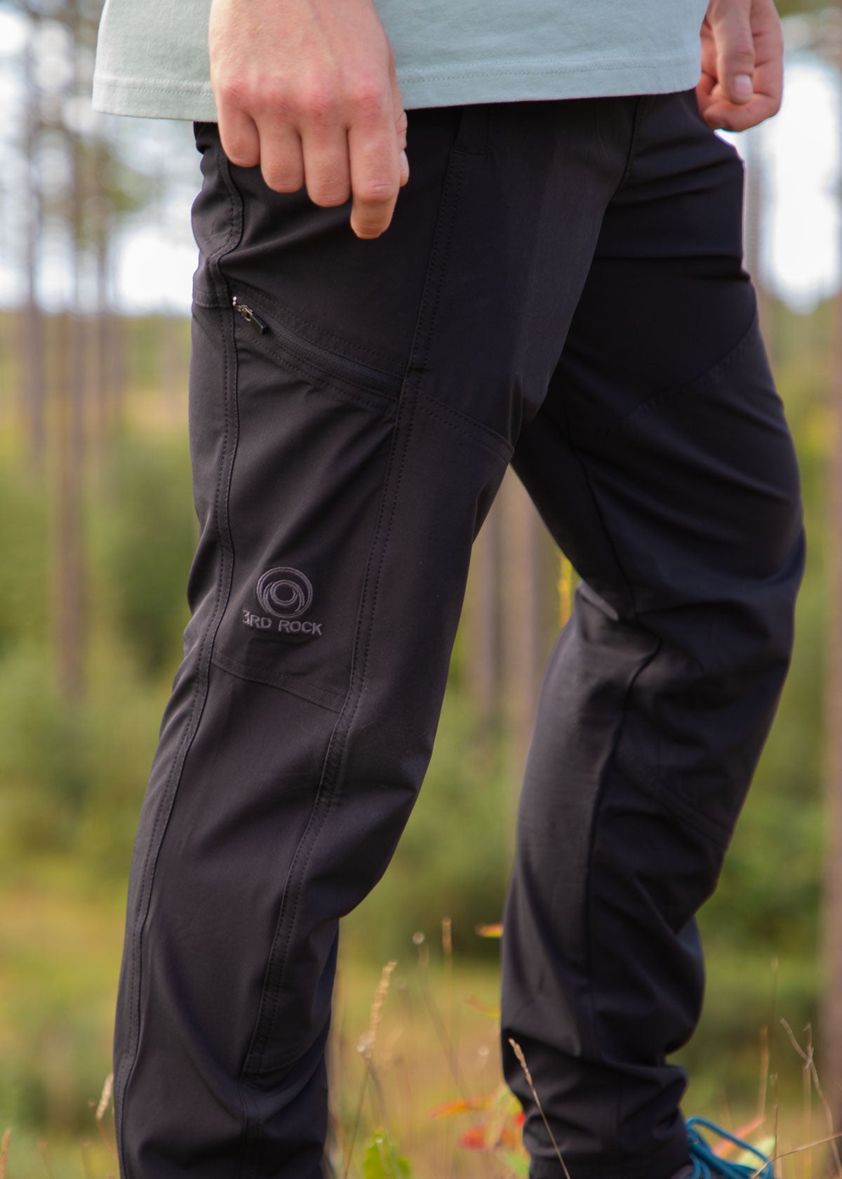 A slightly zoomed photo of the HIRO Light in black showing the cargo pocket and emboirdered logo. M